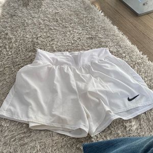 White Nike tennis/running shorts with pockets. Size xs